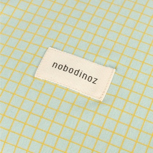 Housse de matelas à langer 50x70cm STORIES Édition limitée Nobodinoz green lemon grid